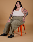 Sam is wearing Corduroy Drop Pocket Cargo Pants in Khaki Grey and Tank Top in Vintage Tee Off-White