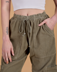 Close up of Corduroy Drop Pocket Cargo Pants in Khaki Grey with Alex's hand in the front pocket