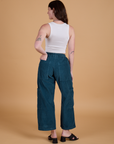 Back view of Corduroy Drop Pocket Cargo Pants in Lagoon and Cropped Tank in Vintage Tee Off-White on Alex