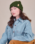 Alex is wearing Ribbed Beanie in Evergreen