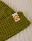 Ribbed Beanie in Olive Green close up of sun baby tag