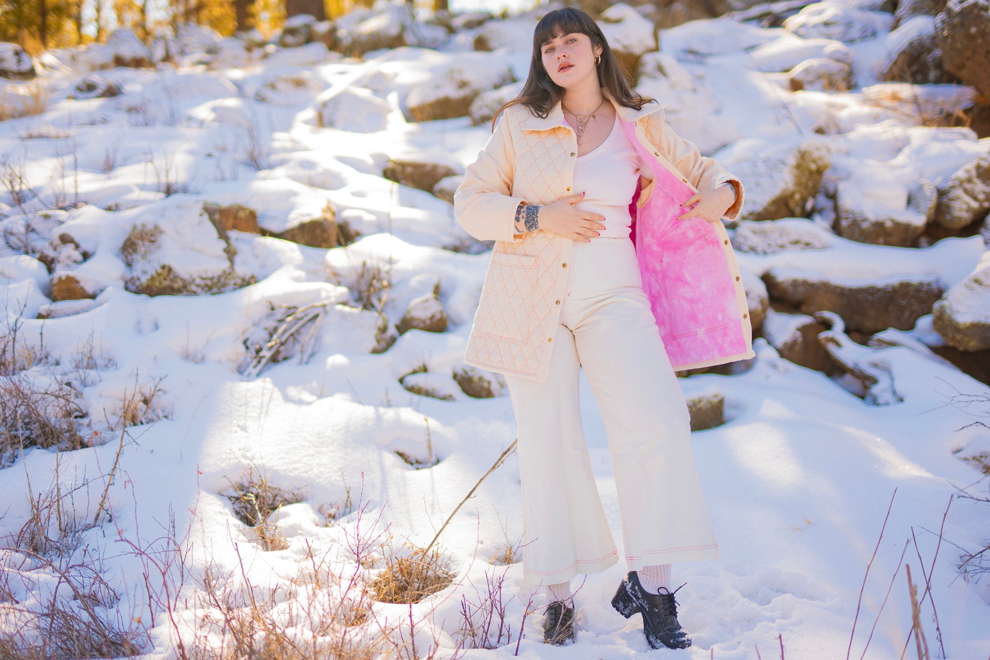 Sydney is wearing Quilted Overcoat in Vintage Off-White, Long Sleeve V-Neck Tee in Vintage Off-White and Bell Bottoms in Vintage Off-White