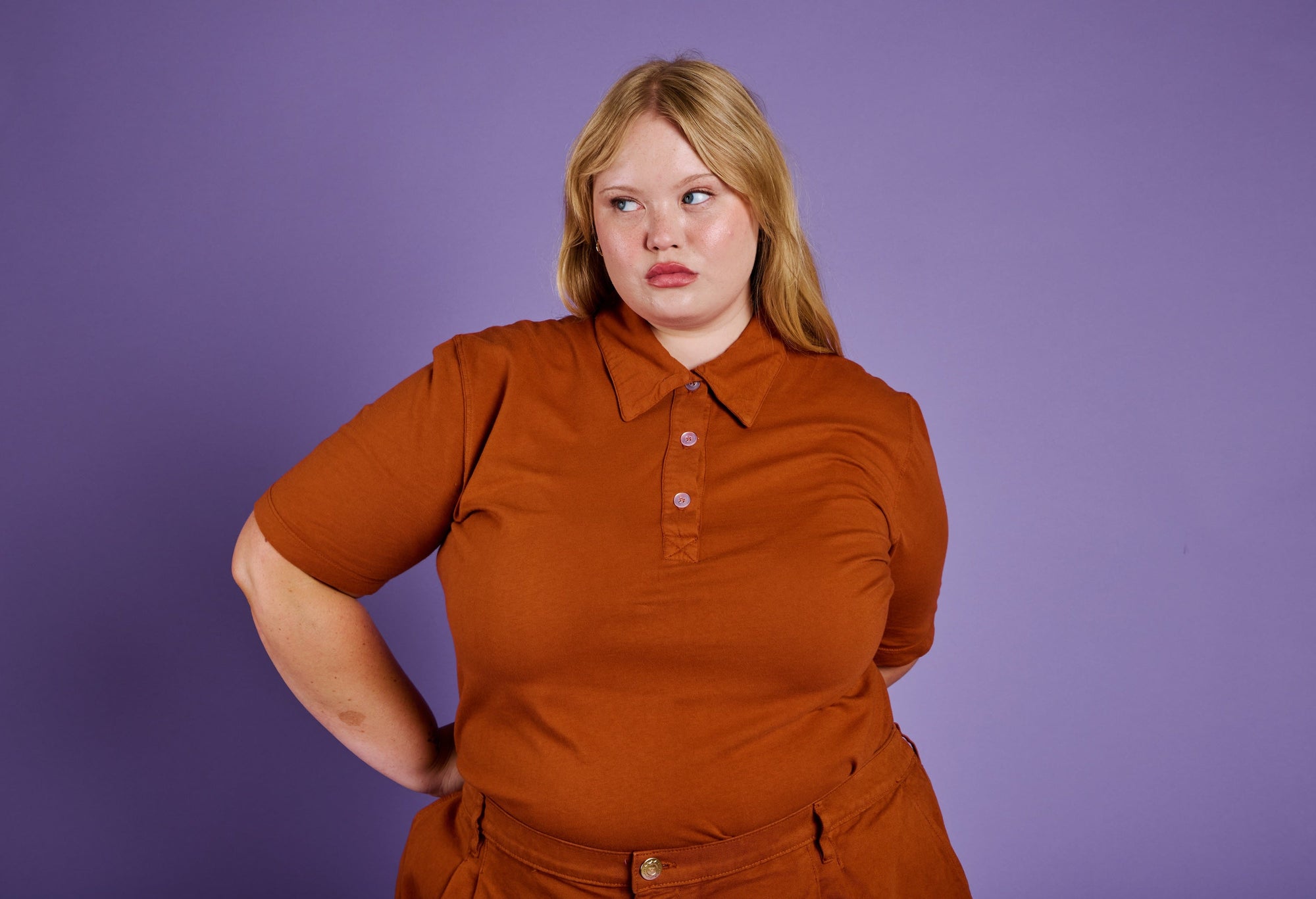 Juliet is wearing Classic Polo in Burnt Terracotta and Pleated Trouser Shorts in Burnt Terracotta