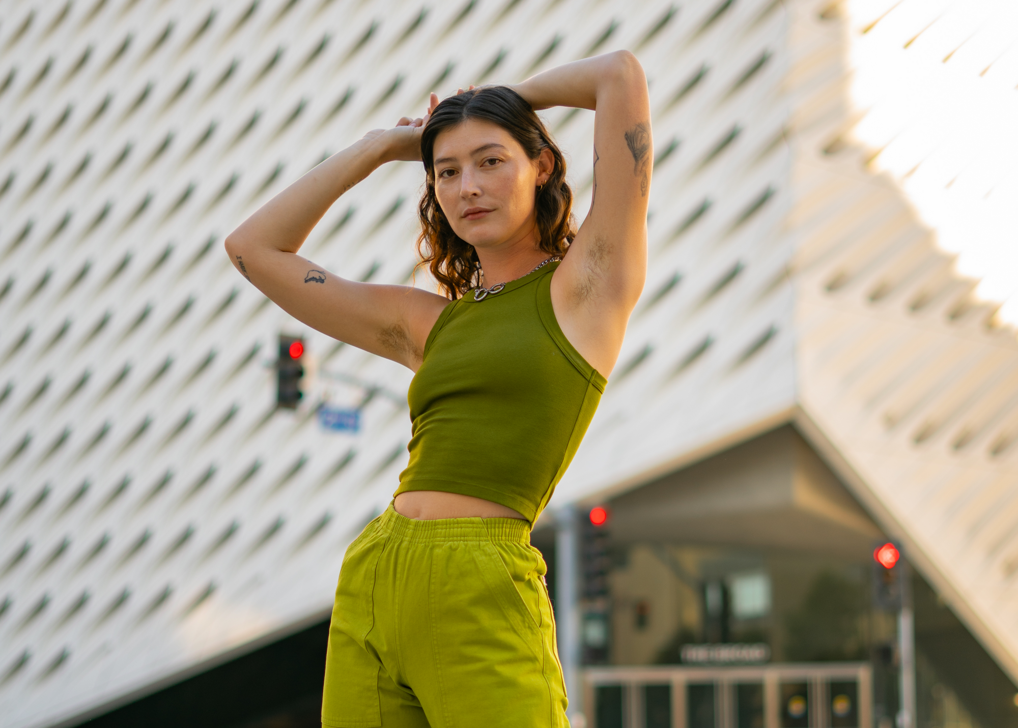 Alexandra Skye is wearing Action Pants in Gross Green and Racerback Tank in Summer Olive