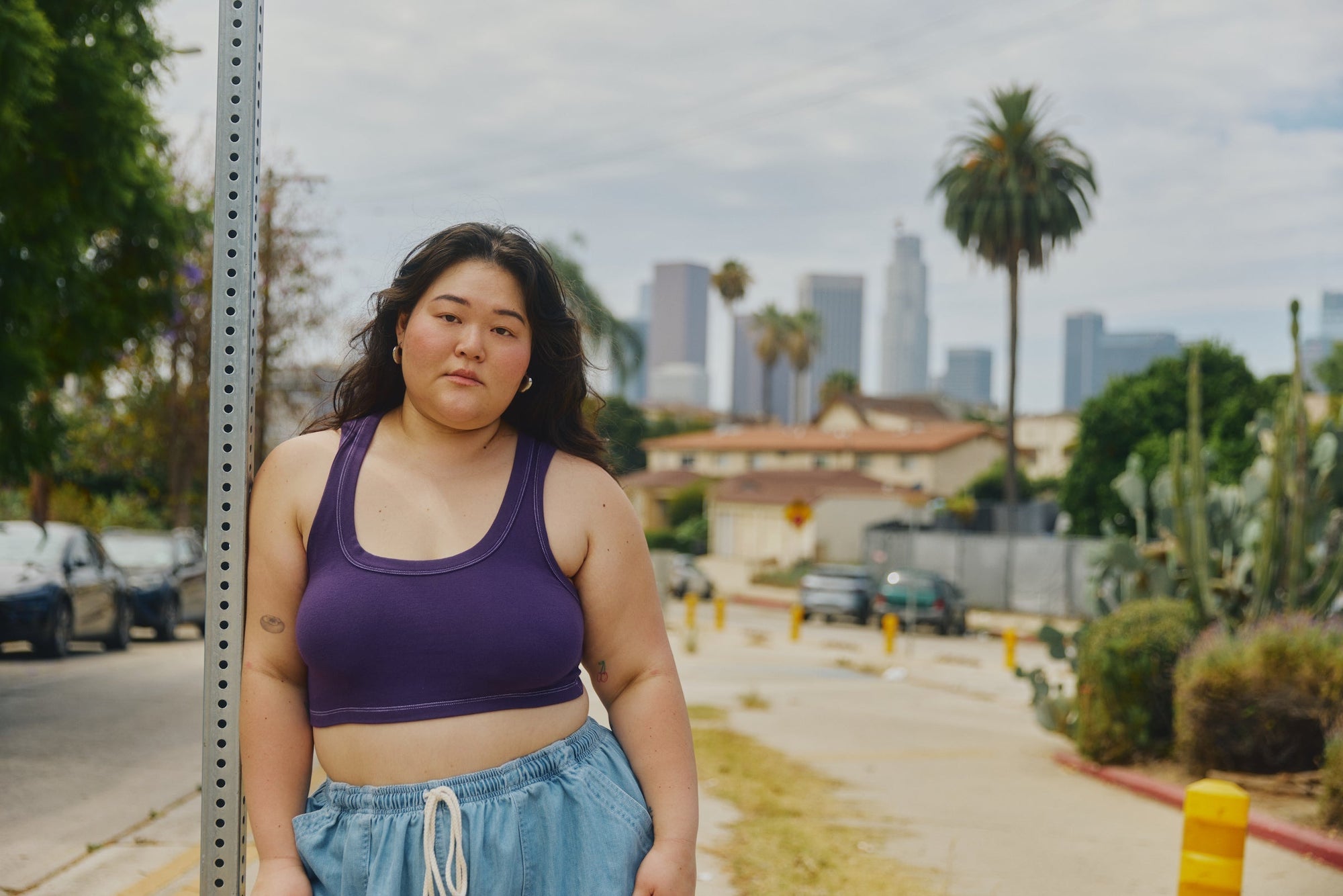 Ashley is wearing Contrast Stitch Mini Tank in Nebula and Denim Drop Pocket Pants in Light Wash