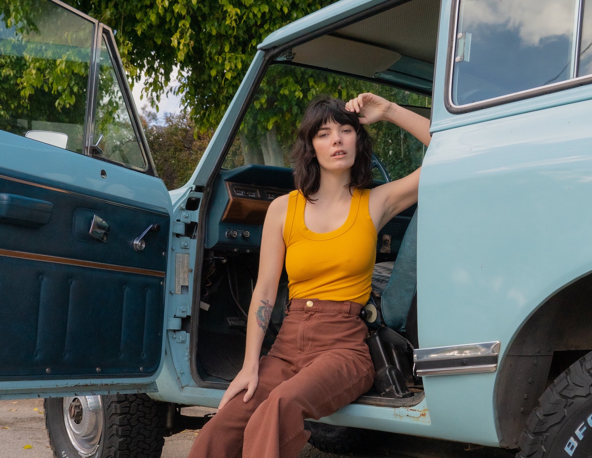 Dani wearing Tank Top in Mustard Yellow and Bell Bottoms in Fudgesicle Brown