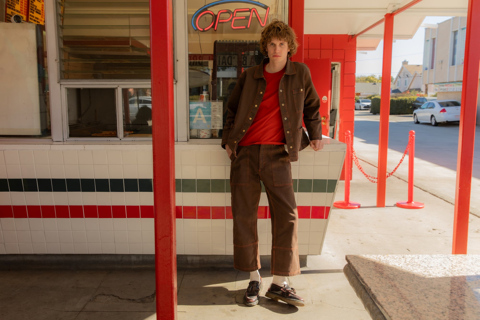 Quinn is wearing Denim Work Jacket in Fudgesicle Brown and matching Carpenter Jeans