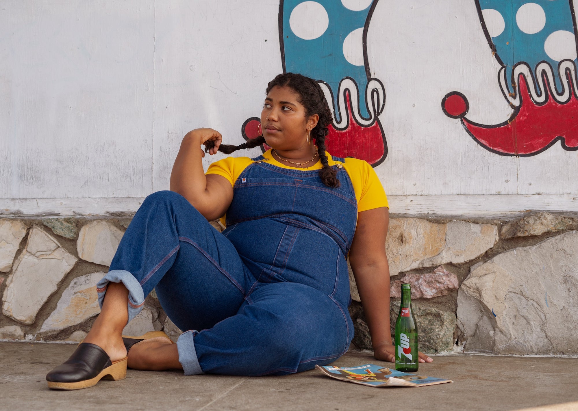 Morgan is wearing Baby Tee in Sunshine Yellow and Indigo Denim Original Overalls in Dark Wash