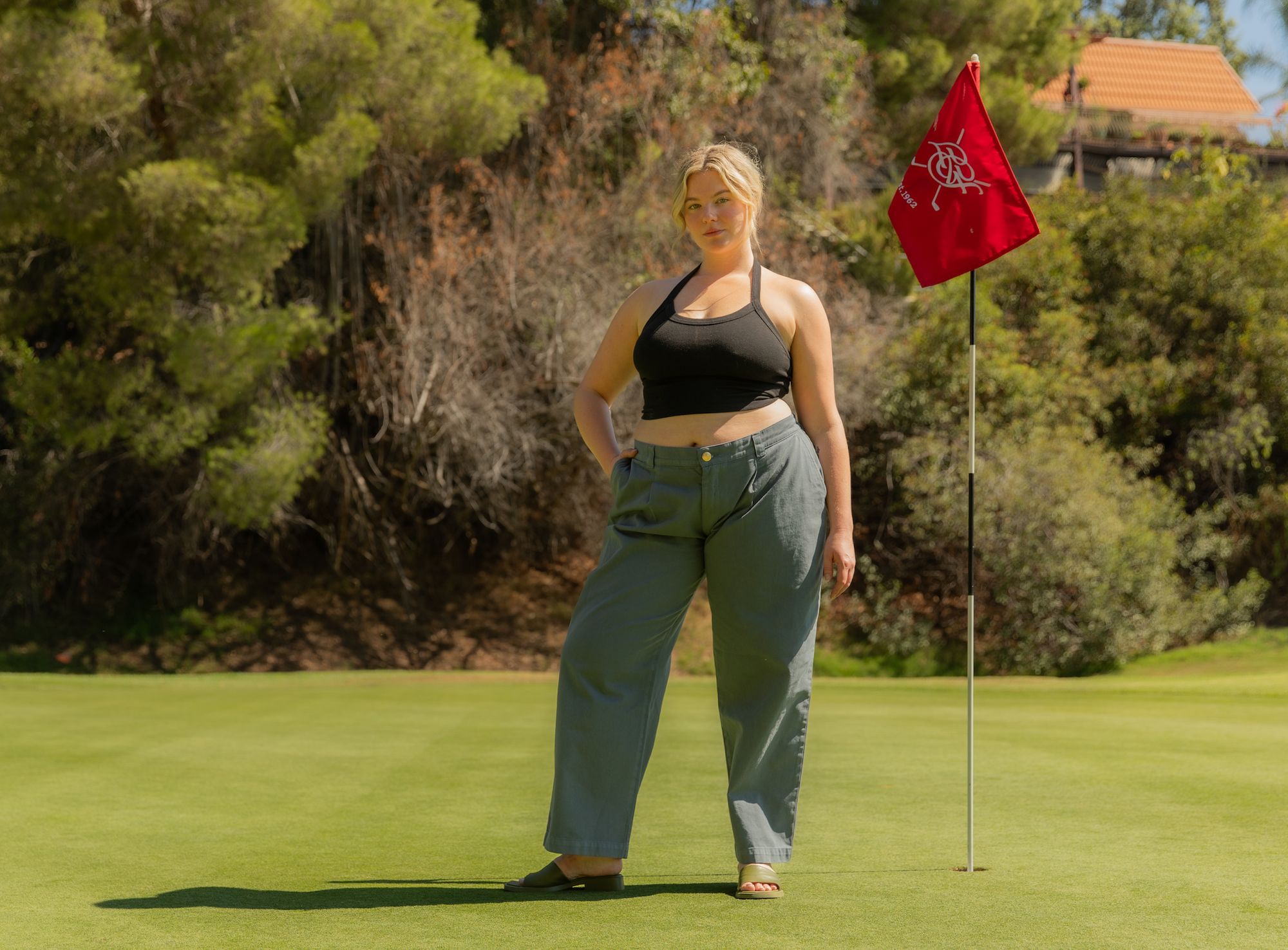 Lish is wearing Halter Top in Basic Black and Mid-Rise Pleated Trousers in Slate Grey
