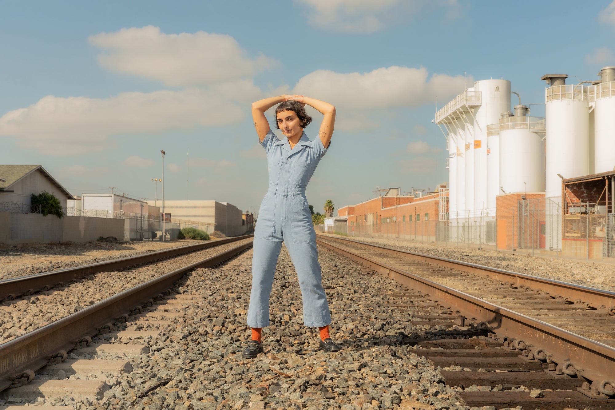 Soraya is wearing Petite Short Sleeve Jumpsuit in Periwinkle