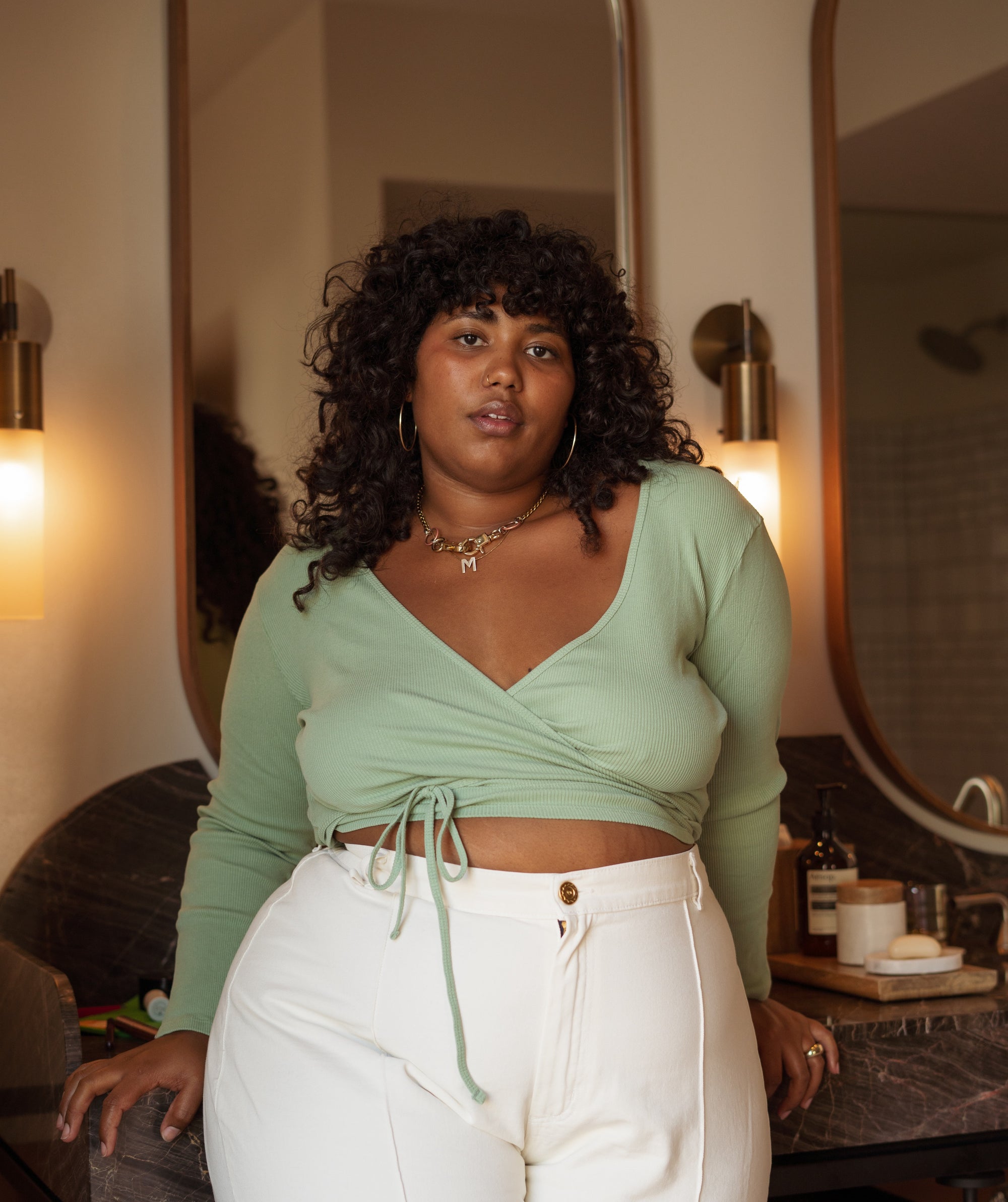 Morgan wearing Wrap Top in Sage Green and Western Pants in Vintage Off-White
