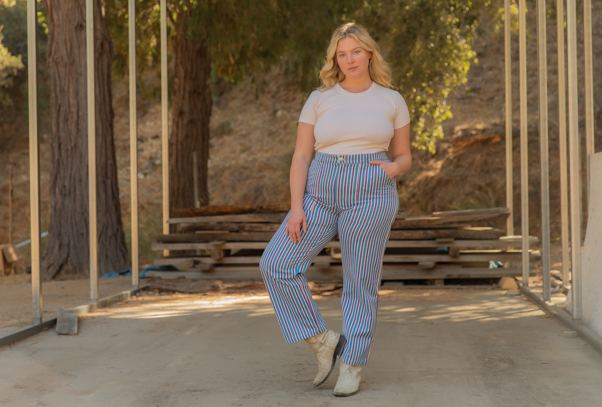 Lish is wearing Baby Tee in Vintage Tee Off-White and Stripe Work Pants in Blue Raspberry