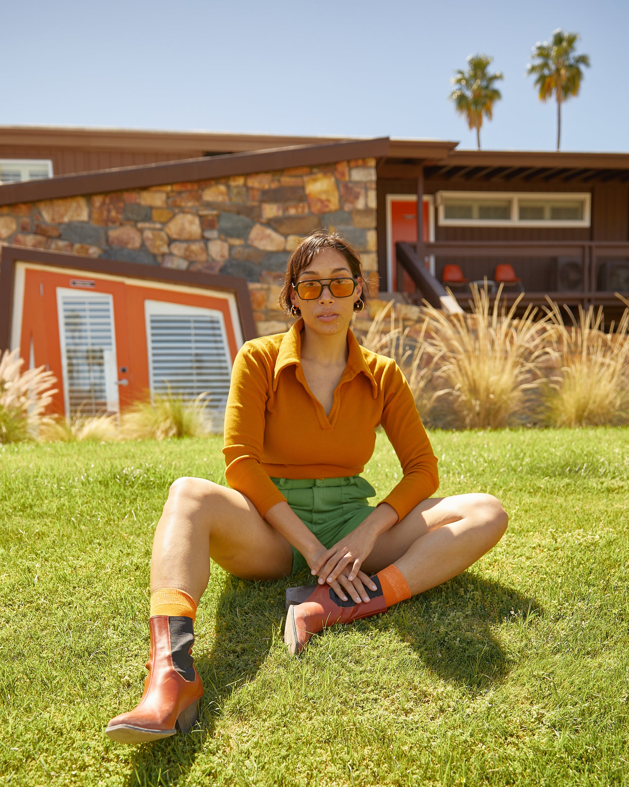 Tiara wearing long sleeve fisherman polo in spicy mustard and work shorts in bright olive