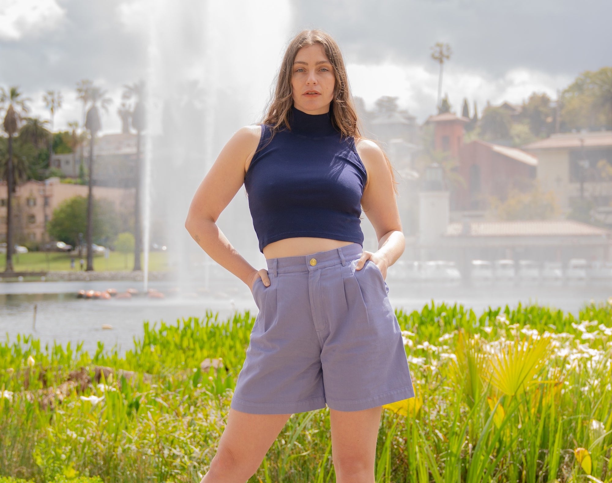 Allison is wearing Sleeveless Essential Turtleneck in Navy Blue and Trouser Shorts in Faded Grape