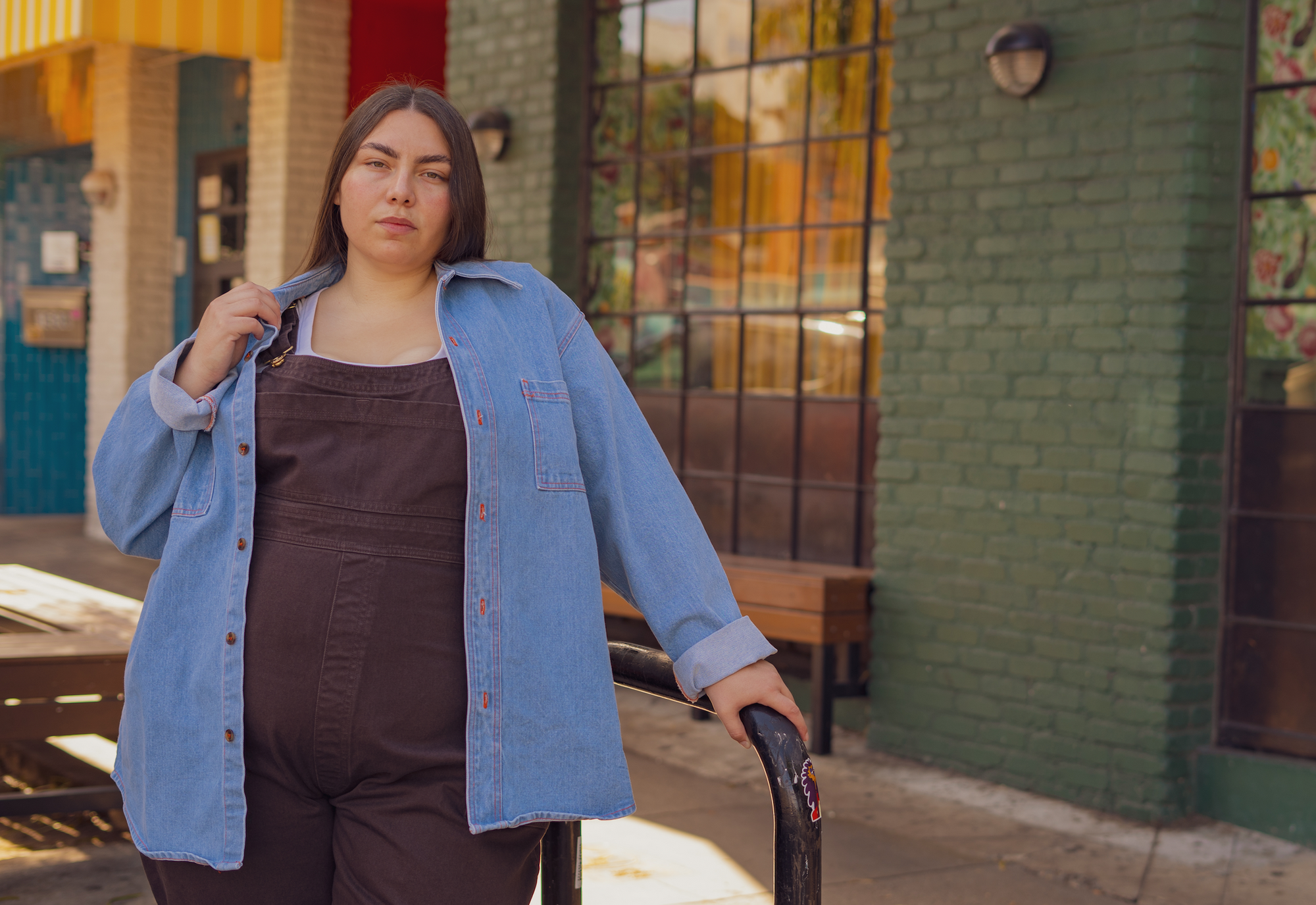 Marielena is wearing Denim Overshirt in Light Wash and Overalls in Mono Espresso Brown