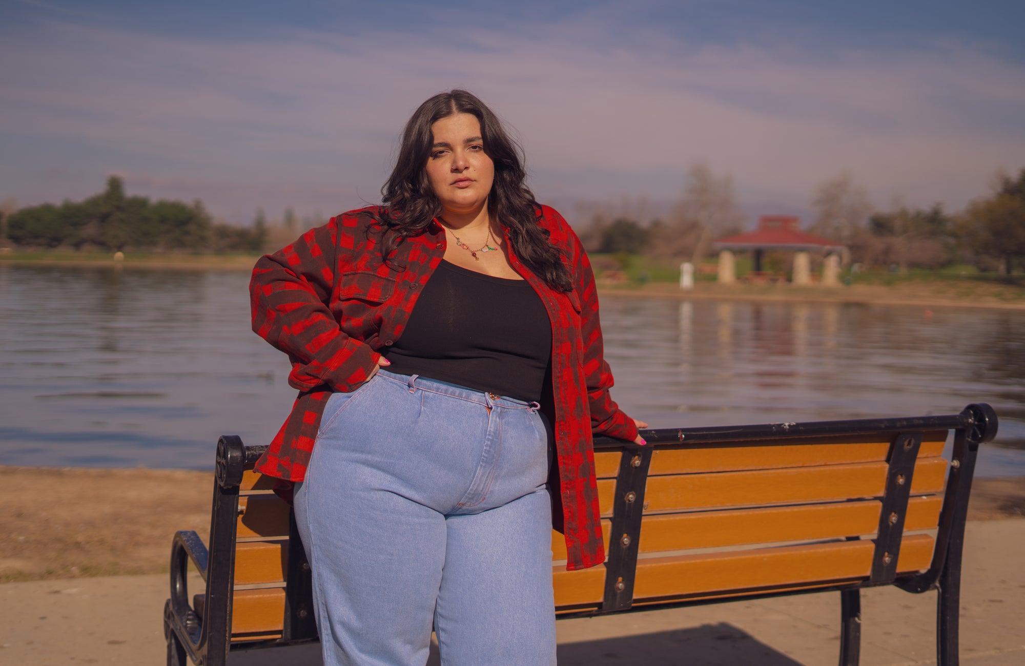 Carmen is wearing Plaid Flannel Overshirt in Paprika, Tank Top in Black and Denim Trousers in Light Wash