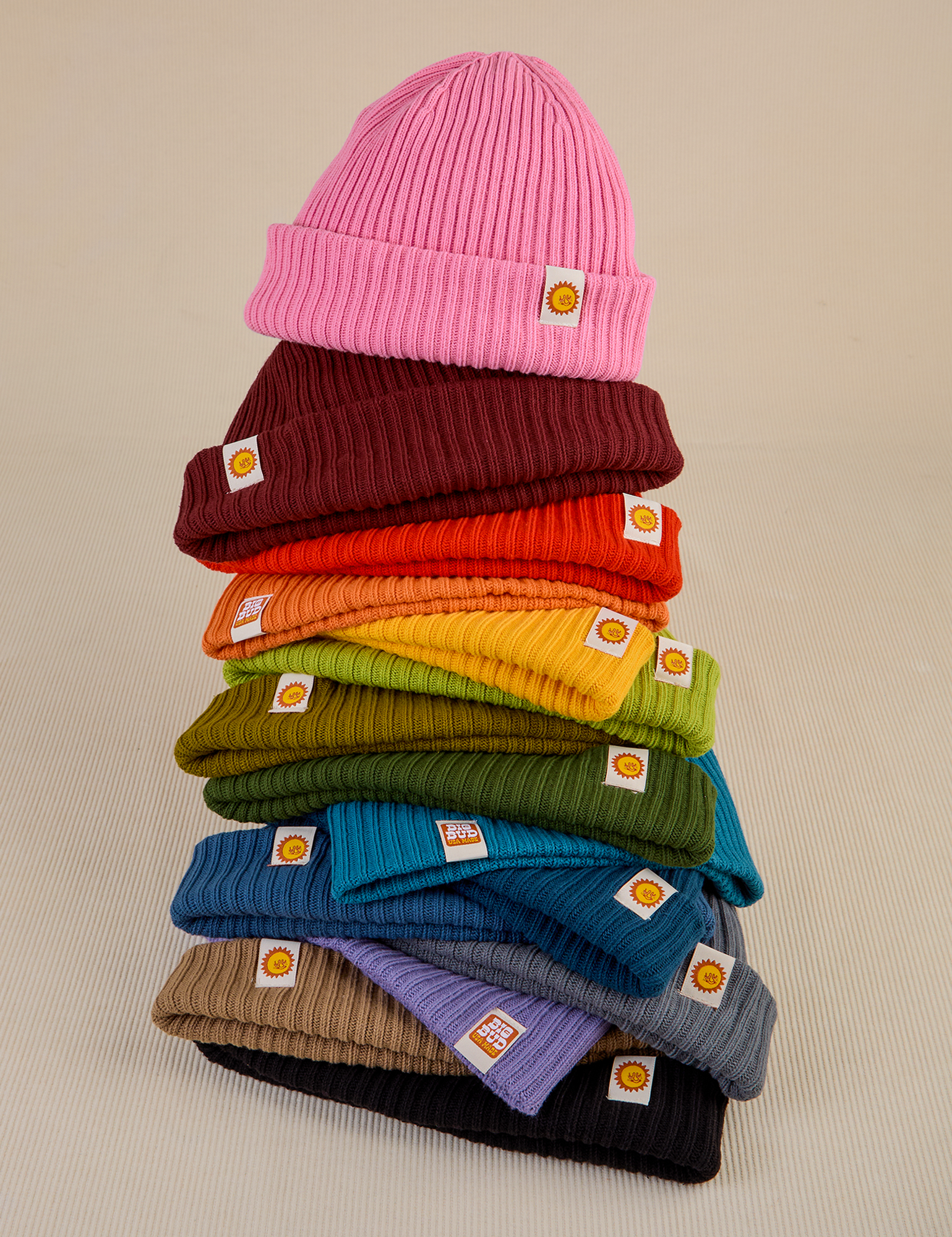 A colorful stack of Ribbed Beanies