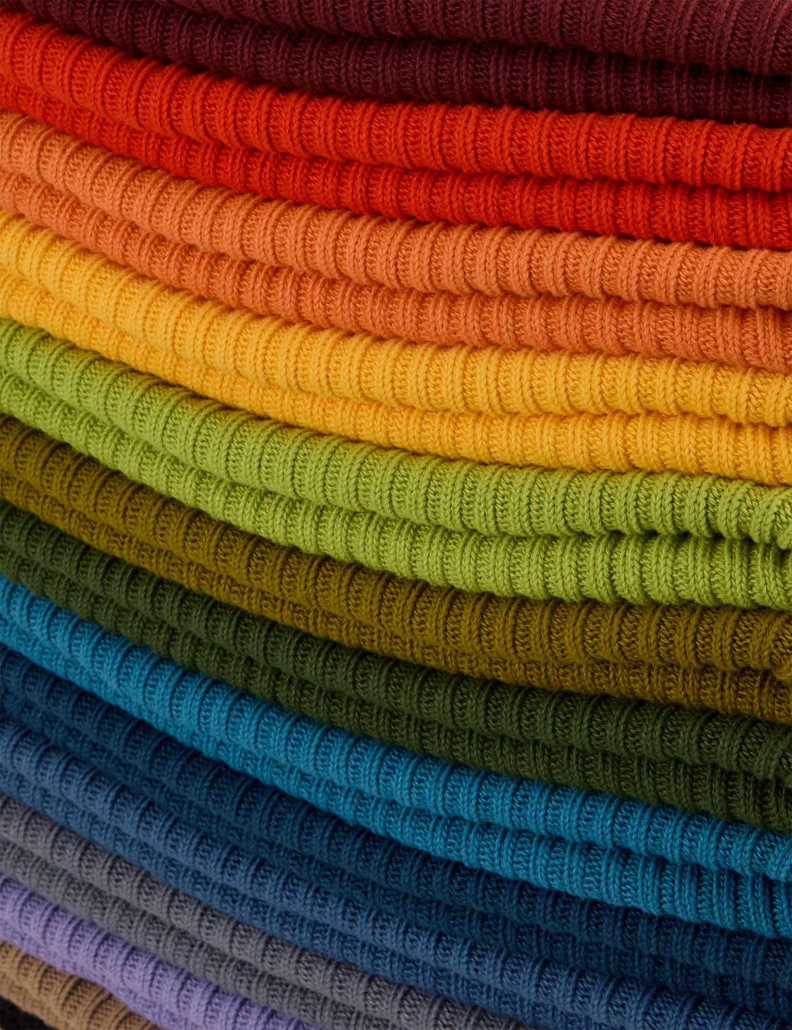 Fabric detail close up of stacked Ribbed Beanies in an array of colors