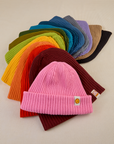 Fanned out collection of Ribbed Beanies in a rainbow of colors