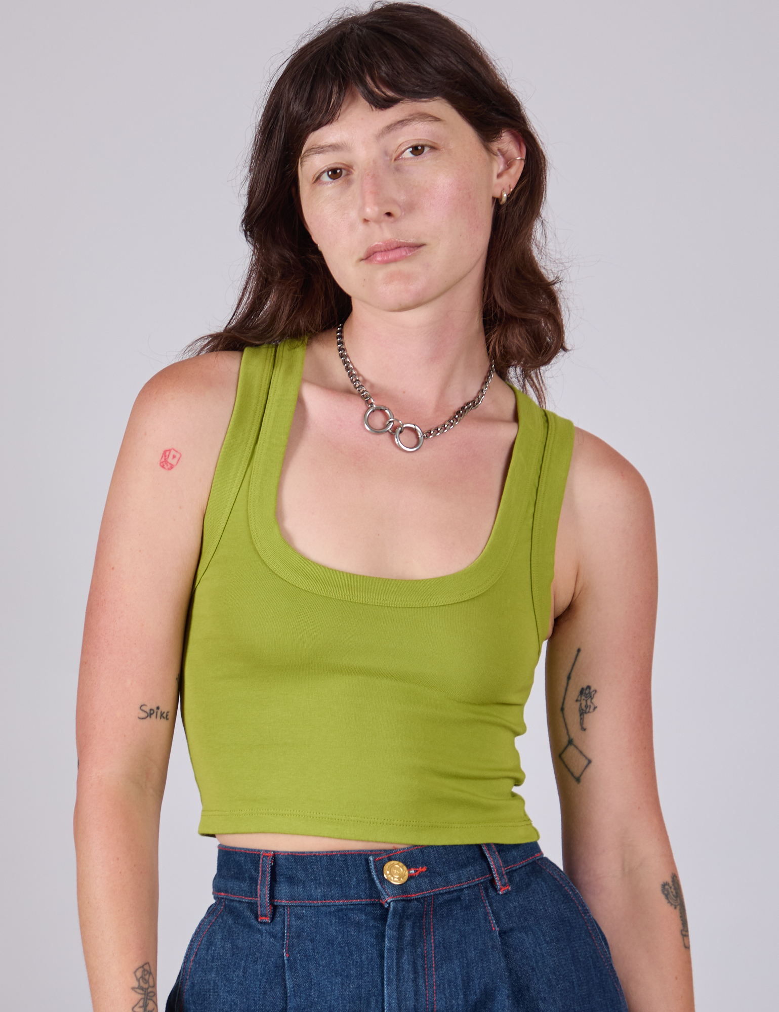Alex is 5'8" and wearing P Cropped Tank Top in Gross Green