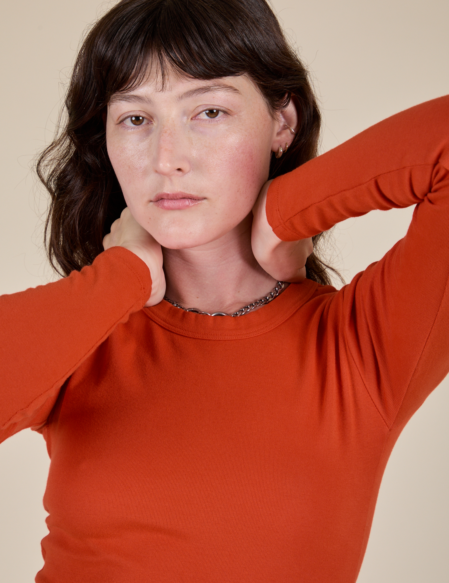 Front close up of Long Sleeve Baby Tee in Chili Red on Alex