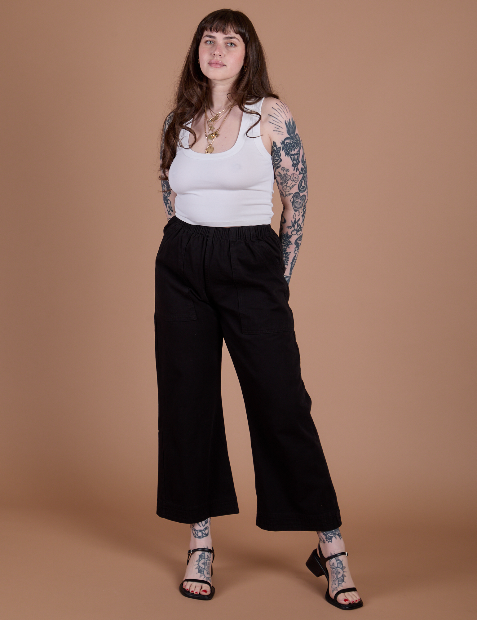 Sydney is 5’9” and wearing M Action Pants in Basic Black paired with Cropped Tank in Vintage Tee White