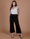Sydney is 5’9” and wearing M Action Pants in Basic Black paired with Cropped Tank in Vintage Tee White