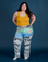 Ashley is 5’7” and wearing 1XL Work Pants in Night Sky Airbrush paired with a mustang yellow Cropped Tank