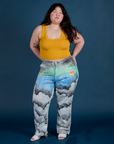 Ashley is 5’7” and wearing 1XL Work Pants in Night Sky Airbrush paired with a mustang yellow Cropped Tank