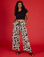 Kandia is 5'3" and wearing XS Cow Drop Pocket Pant with the Black Cropped Baby Tee