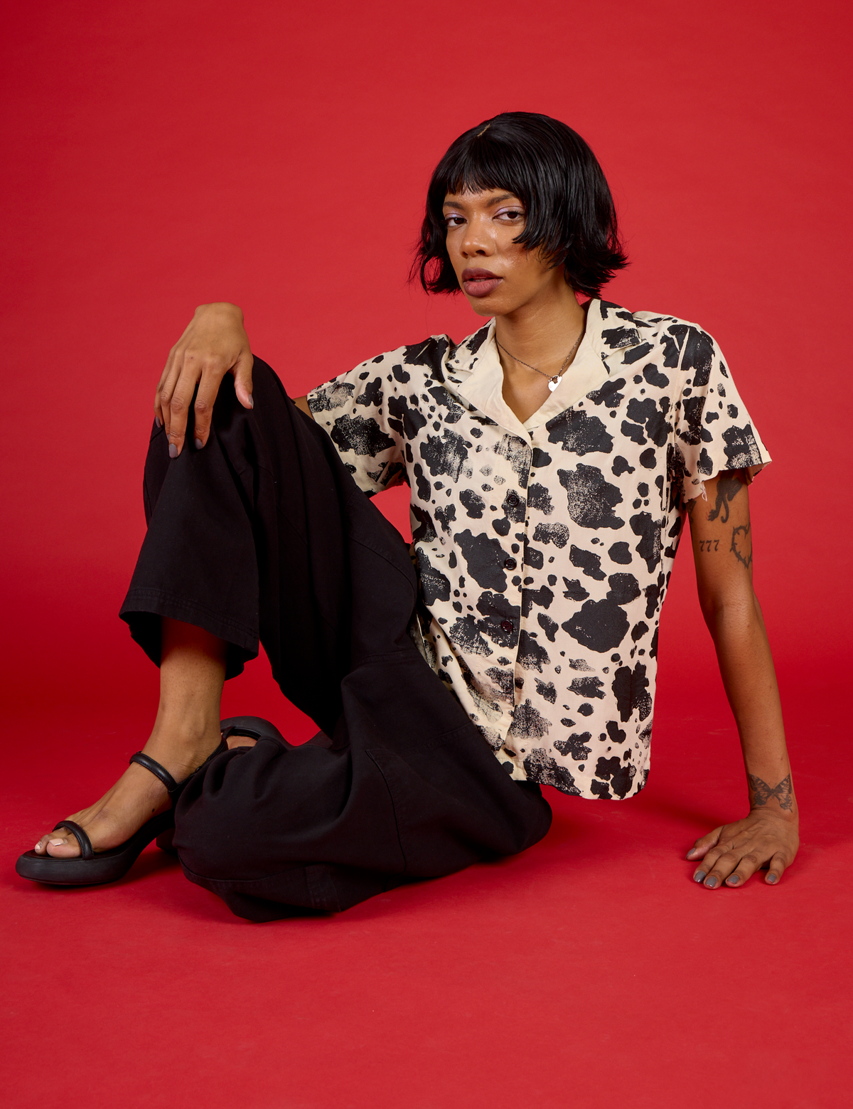 Kira is 5'10" and wearing XXS Cow Pantry Button Up