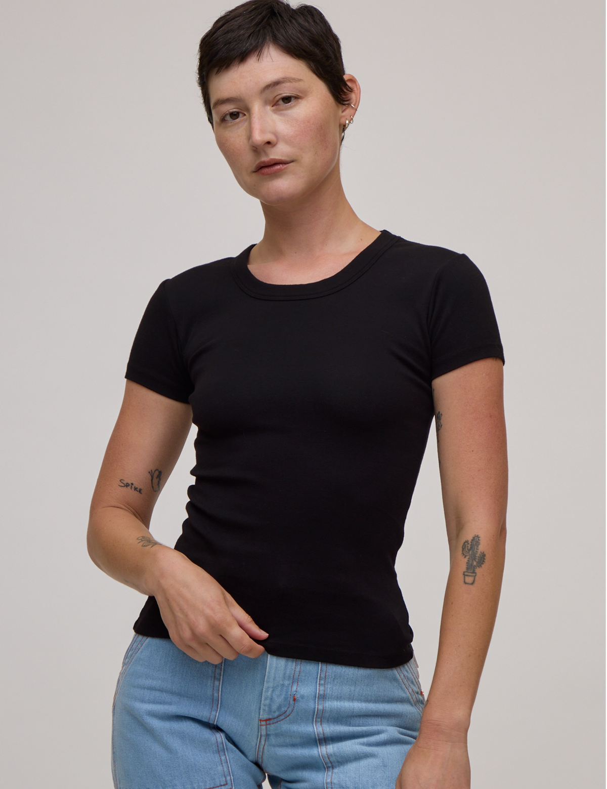 Alex is 5'8" and wearing P Baby Tee in Basic Black