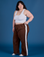 Ashley is 5’7” and wearing 1XL Painted Action Pants in Fudgesicle Brown paired with vintage tee white Cropped Tank