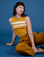 Alex is 5’8” and wearing P Painted Muscle Tee in Mustard Yellow