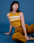 Alex is 5’8” and wearing P Painted Muscle Tee in Mustard Yellow