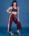 Alex is 5’8” and wearing XXS Painted Drop Pocket Cargo Pants in Red Wine paired with Mini Tank in Red Wine