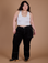 Ashley is 5’7” and wearing 1XL Carpenter Jeans in Black paired with a vintage tee white Cropped Tank