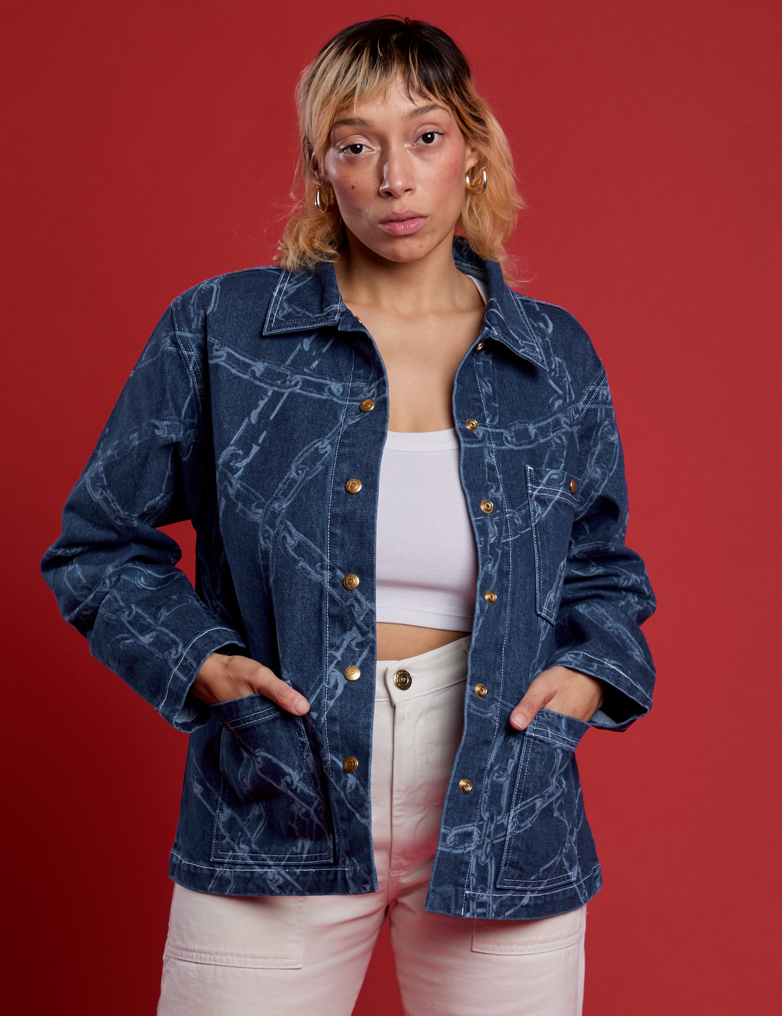 Tiara is 5’4” and wearing S Chain Link Work Jacket paired with a white cami underneath and white work pants