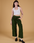 Alex is 5’8” and wearing XXS Corduroy Drop Pocket Cargo Pants in Evergreen paired with a Cropped Tank in Vintage Tee White