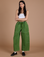Anjaline 5'7" is and wearing XXS Denim Drop Pocket Pants in Green Overdye paired with vintage tee white Cropped Tank