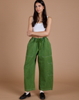 Anjaline 5'7" is and wearing XXS Denim Drop Pocket Pants in Green Overdye paired with vintage tee white Cropped Tank
