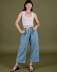 Alex is 5’8” and wearing XXS Denim Drop Pocket Pants in Light Wash paired with vintage tee white Cropped Tank