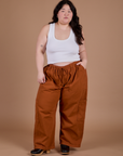 Ashley is 5'7" and wearing 1XL Drop Pocket Cargo Pants in Burnt Terracotta
