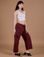 Alex is 5’8” and wearing XXS Drop Pocket Cargo Pants in Red Wine paired with vintage tee white Cropped Tank