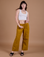 Alex is 5’8” and wearing XXS Drop Pocket Cargo Pants in Spicy Mustard  paired with vintage tee white Cropped Tank