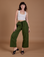 Alex is 5’8” and wearing XXS Drop Pocket Cargo Pants in Evergreen paired with a Cropped Tank in vintage tee white