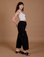 Side view of Drop Pocket Cargo Pants in Basic Black worn by Alex