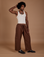 Jerrod is 6’3” and wearing M Drop Pocket Cargo Pants in Fudgesicle Brown paired with a Tank Top in vintage tee white