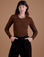 Alex is 5’8” and wearing XP Gingham Long Sleeve Baby Tee in Fudgesicle Brown
