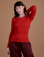Alex is 5’8” and wearing XP Gingham Long Sleeve Baby Tee in Mustang Red